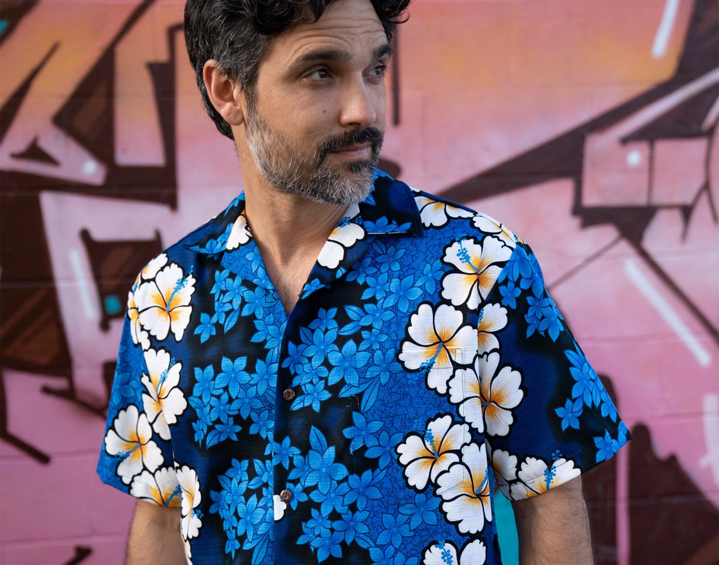 Man wearing the blue Blossoming Hibiscus aloha shirt