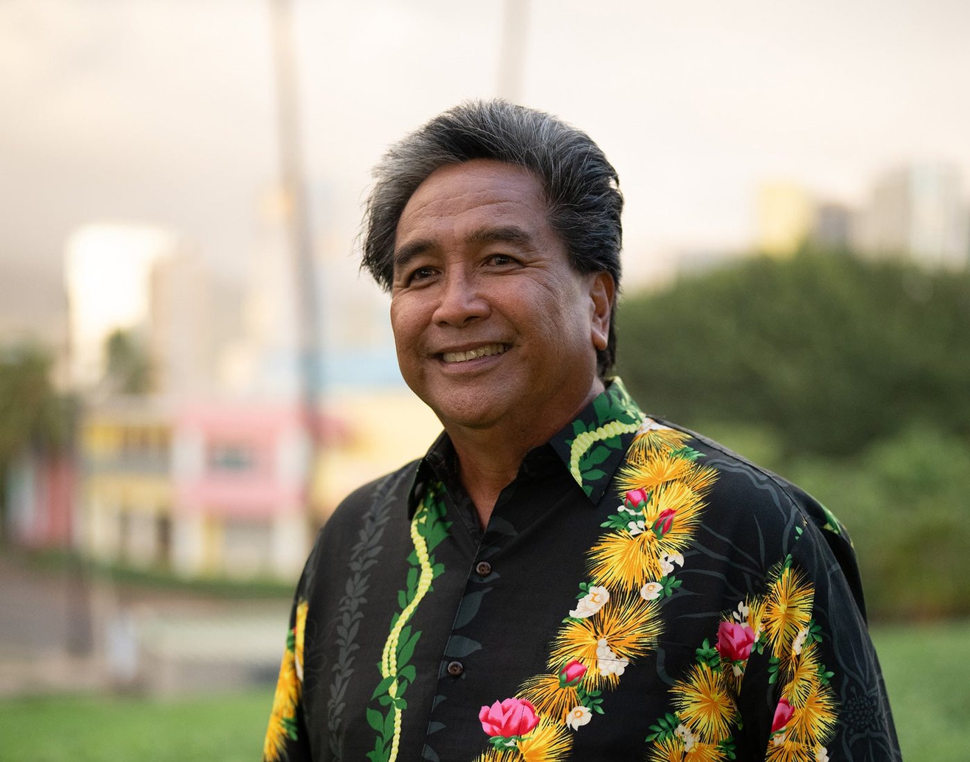 Man in the black Ohia aloha shirt with a yellow lei print